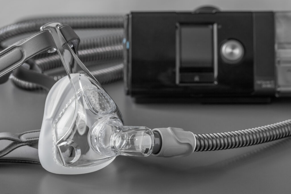 Sleep apnea CPAP mask on the grey table