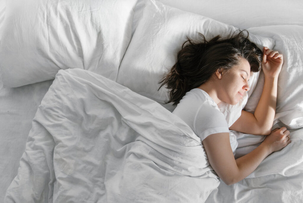 woman sleep in bed sunshine thought the window